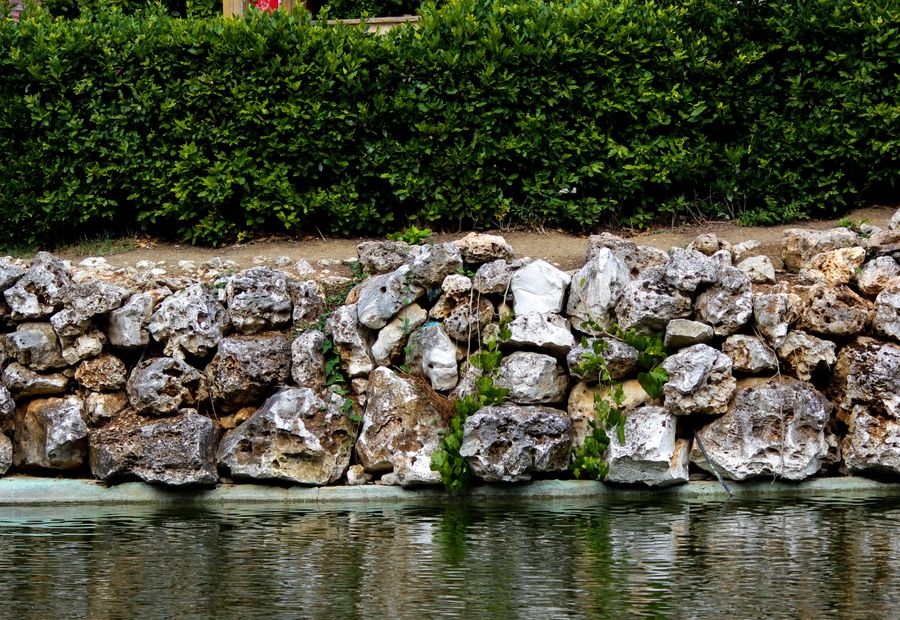 Dolomite boulder wall placed by machine with the toe course set under grade